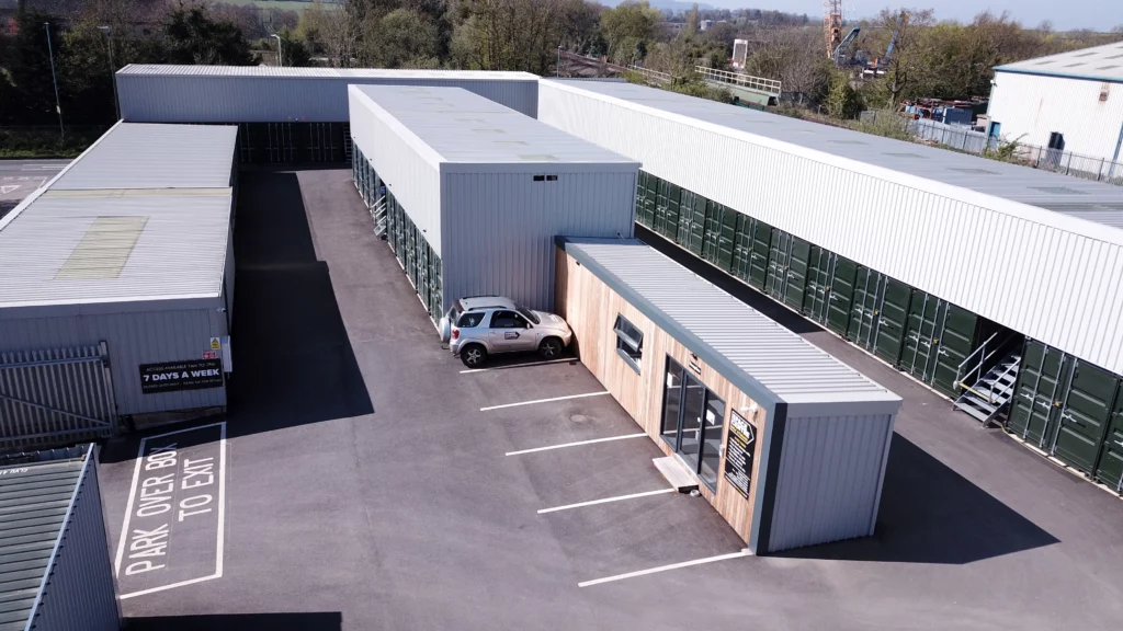 Aerial view of a managed self storage site with reception and container-based storage units in England.